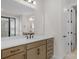 Bright bathroom featuring a modern vanity with quartz countertop, and a separate shower area at 7332 Jolly Brook Dr, Charlotte, NC 28215