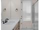 Bright bathroom featuring a modern vanity with quartz countertop, window and separate shower area at 7332 Jolly Brook Dr, Charlotte, NC 28215