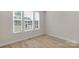 Bedroom with lots of natural light and wood-look flooring at 7332 Jolly Brook Dr, Charlotte, NC 28215