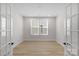 Bedroom with lots of natural light and wood-look flooring at 7332 Jolly Brook Dr, Charlotte, NC 28215