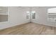 Bright bedroom with wood floors and multiple windows offering natural light at 7332 Jolly Brook Dr, Charlotte, NC 28215
