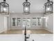 View from the kitchen island into an open living room with bright windows and doors to the backyard at 7332 Jolly Brook Dr, Charlotte, NC 28215