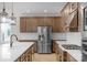 Spacious kitchen with stainless steel refrigerator, white subway tile backsplash, and ample counter space at 7332 Jolly Brook Dr, Charlotte, NC 28215