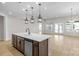Open-concept kitchen with island, stainless dishwasher, and doors to the outside at 7332 Jolly Brook Dr, Charlotte, NC 28215
