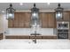 Gourmet kitchen with a cooktop, white subway tile, pendant lighting, and a quartz countertop island at 7332 Jolly Brook Dr, Charlotte, NC 28215