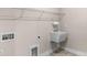 Laundry room with a utility sink, neutral paint, and tile flooring at 7332 Jolly Brook Dr, Charlotte, NC 28215