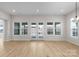 Bright, airy living room with wood floors, multiple windows, and glass patio doors at 7332 Jolly Brook Dr, Charlotte, NC 28215