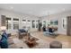 Open living room with couch, dining table, large windows, and wood-look flooring at 7332 Jolly Brook Dr, Charlotte, NC 28215