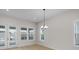 Light-filled living room with wood floors, glass doors, and chandelier at 7332 Jolly Brook Dr, Charlotte, NC 28215