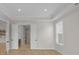 Bedroom features tray ceiling, wood floor and a doorway to a walk-in closet and bathroom at 7332 Jolly Brook Dr, Charlotte, NC 28215