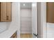 A view into a bright walk-in pantry with wood floors and metal storage shelves at 7332 Jolly Brook Dr, Charlotte, NC 28215