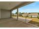 Inviting screened porch with a view of the grassy backyard and houses at 7332 Jolly Brook Dr, Charlotte, NC 28215