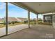 Relaxing screened porch with patio view of backyard and neighboring homes at 7332 Jolly Brook Dr, Charlotte, NC 28215