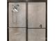Shower with frameless glass door and tile surround, with shower head and seat at 7332 Jolly Brook Dr, Charlotte, NC 28215