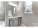 Bathroom featuring gray vanity with large mirror and storage at 7517 Lancaster Hwy # 5, Waxhaw, NC 28173