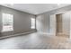 Bedroom featuring wood-look flooring, two windows, and a closet at 7517 Lancaster Hwy # 5, Waxhaw, NC 28173