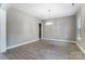 Dining room featuring light hardwood floors, neutral walls, and a modern chandelier at 7517 Lancaster Hwy # 5, Waxhaw, NC 28173