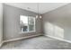 Dining room featuring wood-look flooring, a modern chandelier, and a large window at 7517 Lancaster Hwy # 5, Waxhaw, NC 28173