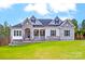 Stunning exterior view of a two-story home featuring stone accents, blue shutters, and a meticulously maintained lawn at 7517 Lancaster Hwy # 5, Waxhaw, NC 28173