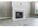 Modern fireplace featuring a white mantle and marble hearth with light colored vinyl flooring at 7517 Lancaster Hwy # 5, Waxhaw, NC 28173