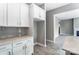An elegant kitchen with white cabinetry, gray backsplash, and an open layout leading to the living area at 7517 Lancaster Hwy # 5, Waxhaw, NC 28173