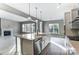 An open concept kitchen featuring a large island with a sink, stainless steel appliances and hardwood flooring at 7517 Lancaster Hwy # 5, Waxhaw, NC 28173
