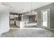 A modern kitchen featuring a large island and stainless steel appliances, seamlessly flowing into a living space at 7517 Lancaster Hwy # 5, Waxhaw, NC 28173
