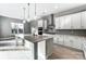 Modern kitchen boasts white cabinets, stainless steel appliances, a large island and pendant lighting at 7517 Lancaster Hwy # 5, Waxhaw, NC 28173