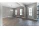Open living space showcasing hardwood floors, bright lighting, and a white door to the exterior at 7517 Lancaster Hwy # 5, Waxhaw, NC 28173