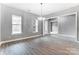 Bright living room featuring light hardwood floors, neutral walls, and natural light coming in from the windows at 7517 Lancaster Hwy # 5, Waxhaw, NC 28173