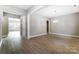 Spacious living room featuring hardwood floors, neutral walls, and an elegant light fixture above at 7517 Lancaster Hwy # 5, Waxhaw, NC 28173