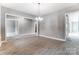 Large living room with light wood flooring, neutral walls, and an open layout leading to other rooms at 7517 Lancaster Hwy # 5, Waxhaw, NC 28173