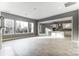 Bright living room with a large window and entry to kitchen with white cabinets and a kitchen island at 7517 Lancaster Hwy # 5, Waxhaw, NC 28173