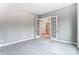 Bright room with gray walls, open french doors, and plush gray carpet flooring at 7517 Lancaster Hwy # 5, Waxhaw, NC 28173