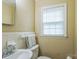 Bathroom featuring a sink, toilet, a window with blinds, and neutral colored walls at 814 Rhodann Dr, Shelby, NC 28152