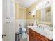 Bathroom with white tile, dark wood vanity, toilet, and lighting over the sink at 814 Rhodann Dr, Shelby, NC 28152