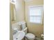 Bathroom featuring a sink, toilet, a window with blinds, and neutral colored walls at 814 Rhodann Dr, Shelby, NC 28152