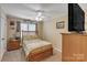 This cozy bedroom features a wood frame bed, bedside table, and ceiling fan at 814 Rhodann Dr, Shelby, NC 28152