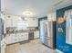 Bright kitchen with white cabinets, stainless steel appliances, and contrasting blue walls at 814 Rhodann Dr, Shelby, NC 28152