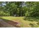 Exterior image of the backyard has mature trees and small storage shed at 844 Fieldstone Rd, Mooresville, NC 28115