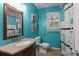 Bright bathroom featuring an undermount sink, decorative mirror, and vibrant walls at 844 Fieldstone Rd, Mooresville, NC 28115