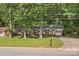 Charming brick home with mature trees, well-maintained lawn, and an inviting curb appeal at 844 Fieldstone Rd, Mooresville, NC 28115
