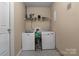 Convenient laundry room with modern washer and dryer, complemented by neutral walls and flooring at 844 Fieldstone Rd, Mooresville, NC 28115