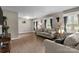 Bright living room featuring hardwood floors, cozy seating, and natural light streaming through the windows at 844 Fieldstone Rd, Mooresville, NC 28115