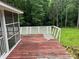 View of weathered wooden back porch featuring a lattice railing and steps down to the backyard at 8524 Anette Ave, Mint Hill, NC 28227