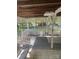 An outdoor back porch featuring a swing, white fencing and view of the wooded yard at 8524 Anette Ave, Mint Hill, NC 28227