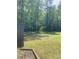 Large private backyard surrounded by mature trees, offering a peaceful and secluded setting at 8524 Anette Ave, Mint Hill, NC 28227