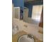 Bathroom sink and mirror with natural light and tiled walls at 8524 Anette Ave, Mint Hill, NC 28227