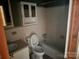 Bathroom with tiled walls, tub, toilet and sink at 8524 Anette Ave, Mint Hill, NC 28227