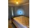 Modest bedroom with a small window, pale blue walls and curtains and carpeted floors at 8524 Anette Ave, Mint Hill, NC 28227